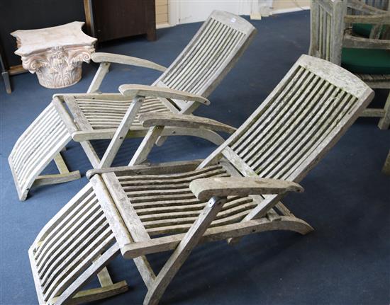 A pair of Indian Ocean teak folding loungers